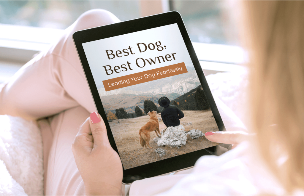 Person holding a tablet with ‘Best Dog, Best Owner – Leading Your Dog Fearlessly’ cover—UltraK9 Pro bonus.”